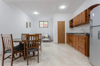a kitchen and dining room with a table and chairs at Apartahotel La Gruta in Jericó