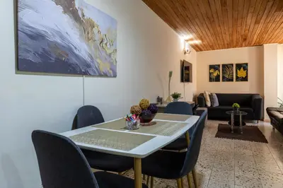 a living room with a table and chairs and a couch at apartamento grande, hermoso, acogedor y privado in Medellín