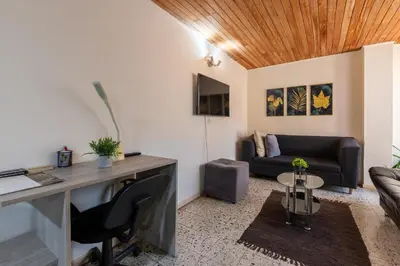 an office with a desk and a couch at apartamento grande, hermoso, acogedor y privado in Medellín