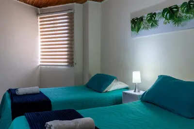 a bedroom with two beds and a window at apartamento grande, hermoso, acogedor y privado in Medellín
