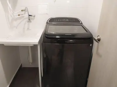 a kitchen with a sink and a black dishwasher at Confortable apartamento in Manizales