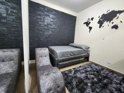 a room with a bed and a chair at Alojamiento con Aire acondicionado - Shelter La Perla in San Luis
