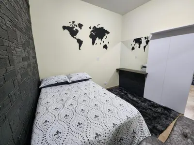 a bedroom with a bed with a map on the wall at Alojamiento con Aire acondicionado - Shelter La Perla in San Luis