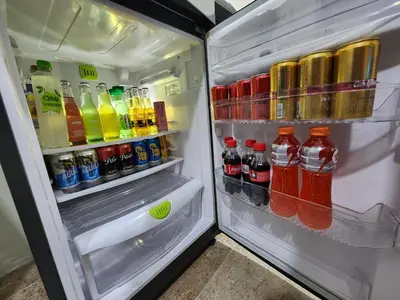 an open refrigerator filled with drinks and sodas at Alojamiento con Aire acondicionado - Shelter La Perla in San Luis