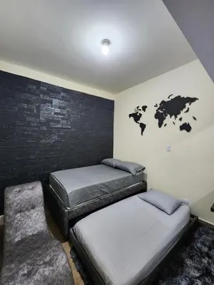 a bedroom with two beds and a map of the world on the wall at Alojamiento con Aire acondicionado - Shelter La Perla in San Luis