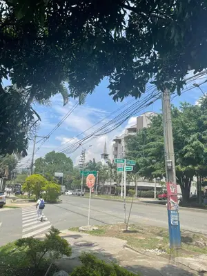 a person walking down a street in a city at Apartamento en laureles con excelente ubicación in Medellín
