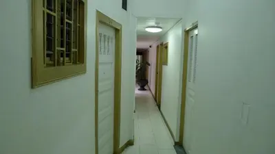 a hallway with white walls and a hallway with at Hotel Las Rampas in Medellín