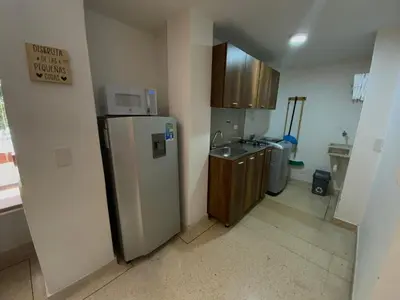 a small kitchen with a refrigerator and a sink at Amoblados Medellín Laureles in Medellín