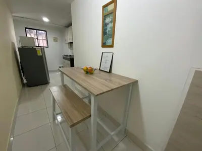a kitchen with a wooden table and a refrigerator at Amoblados Medellín Laureles in Medellín