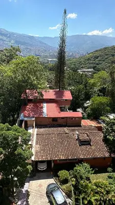 an aerial view of a house with cars parked in front at Pilarica Gardens in Medellín