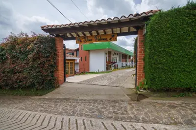 an entrance to a brick building with an archway at Finca Hotel 12 Palmas- Aeropuerto JMC in Rionegro