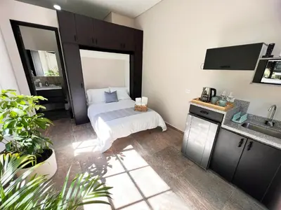 a bedroom with a bed and a sink in it at 1714 Hotel Boutique Guatapé in Guatapé