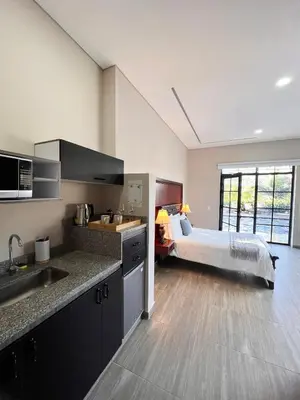 a kitchen with a bed in a room at 1714 Hotel Boutique Guatapé in Guatapé