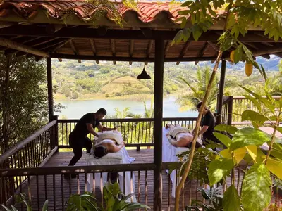 a group of people standing on a deck with two animals at 1714 Hotel Boutique Guatapé in Guatapé