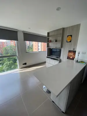 a kitchen with a white counter and a large window at 1213 Suite Moderna - Confort zona rosa poblado in Medellín