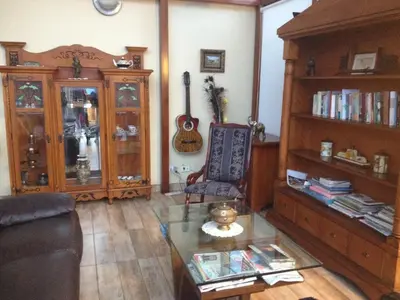 a living room with a glass table and a guitar at Mirador Finca Morrogacho in Manizales