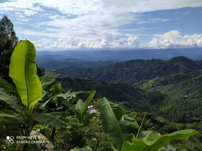 a view from the top of a mountain with green hills at Mirador Finca Morrogacho in Manizales