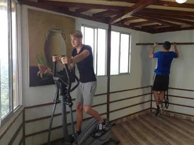 two men on an exercise bike in a room at Mirador Finca Morrogacho in Manizales