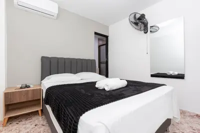 a bedroom with a bed with two white pillows on it at Hotel De León Estadio in Medellín