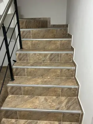 a staircase with wooden flooring and metal railings at Medellin, elegante y central apartamento in Medellín