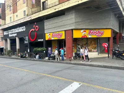 a store on a street with people walking in front of it at Medellin, elegante y central apartamento in Medellín