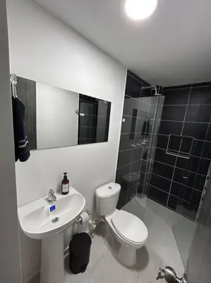 a bathroom with a toilet and a sink and a shower at Medellin, elegante y central apartamento in Medellín
