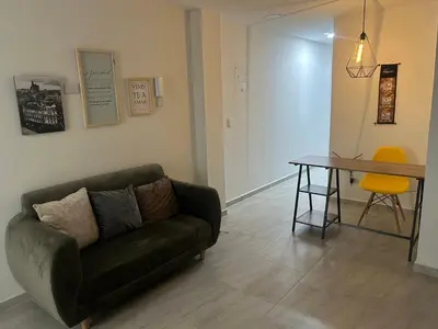 a living room with a couch and a table at Medellin, elegante y central apartamento in Medellín