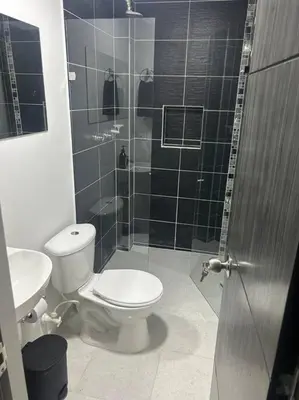 a bathroom with a toilet and a shower and a sink at Medellin, elegante y central apartamento in Medellín