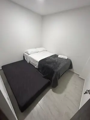 a bed in a room with a black mattress at Medellin, elegante y central apartamento in Medellín