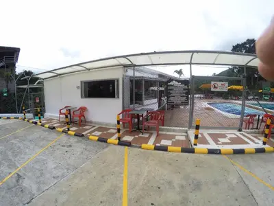 a building with a picnic table and a pool at Sky Club Eco Hotel in Belén de Umbría