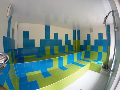 a bathroom with a shower with colorful tiles on the wall at Sky Club Eco Hotel in Belén de Umbría