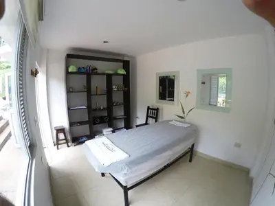 a bedroom with a bed in a white room at Sky Club Eco Hotel in Belén de Umbría