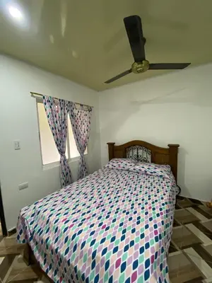 a bedroom with a bed and a ceiling fan at Apartamento bustos in Puerto Triunfo
