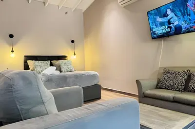 a living room with a couch and a tv on the wall at Dos habitaciones, amplio, estrategicamente ubicado in El Poblado