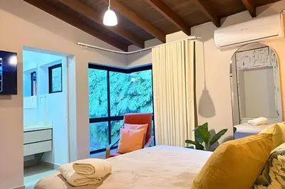 a bedroom with a bed and a desk and a window at NUEVA Mansion con piscina y jacuzzi, El Poblado in El Poblado
