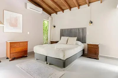 a bedroom with a large bed and a window at NUEVA Mansion con piscina y jacuzzi, El Poblado in El Poblado