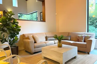 a living room with a couch and a coffee table at NUEVA Mansion con piscina y jacuzzi, El Poblado in El Poblado