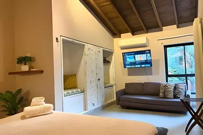 a bedroom with a bed and a couch at NUEVA Mansion con piscina y jacuzzi, El Poblado in El Poblado
