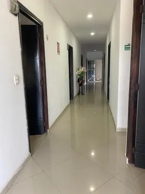 an empty hallway of a building with a vase of flowers at Hotel Malecon Puerto Berrio in Puerto Berrío