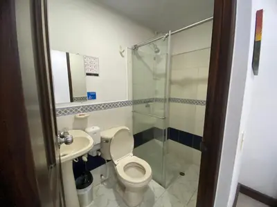 a bathroom with a toilet and a sink and a shower at Hotel Malecon Puerto Berrio in Puerto Berrío