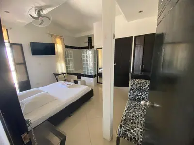 a small bedroom with a bed and a bathroom at Hotel Malecon Puerto Berrio in Puerto Berrío