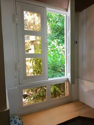 a window in a room with a view of a tree at Estudio Duplex Vintage en el Centro para 4H Atelier in Medellín