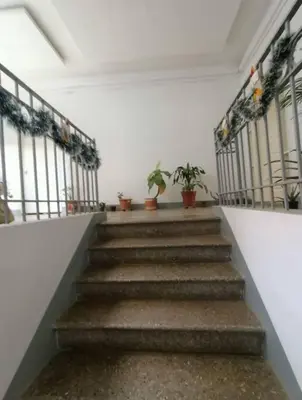 a staircase in a building with potted plants at Estudio Duplex Vintage en el Centro para 4H Atelier in Medellín