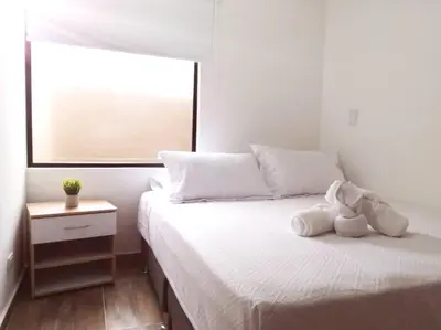 a bedroom with a bed with a stuffed animal on it at Apartamento en Medellín cerca al poblado in Medellín