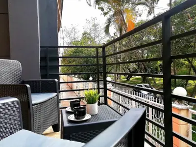 a balcony with a table with two cups on it at Apartamento en Medellín cerca al poblado in Medellín