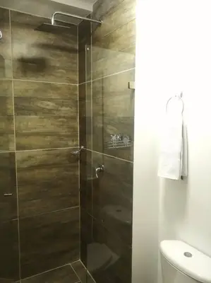 a shower with a glass door in a bathroom at Apartamento en Medellín cerca al poblado in Medellín