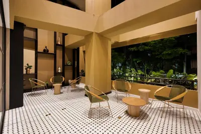 a group of chairs and tables in a building at Nakúa Stay & Work Hotel in Medellín
