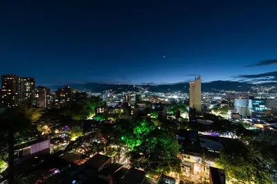 a view of a city at night at Nakúa Stay & Work Hotel in Medellín