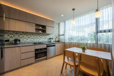 a kitchen with a table and chairs and a dining room at Nakúa Stay & Work Hotel in Medellín