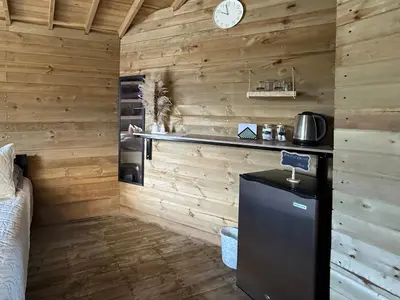a kitchen with wooden walls and a counter in a room at La Peña Cabins - Ebéjico in Ebéjico